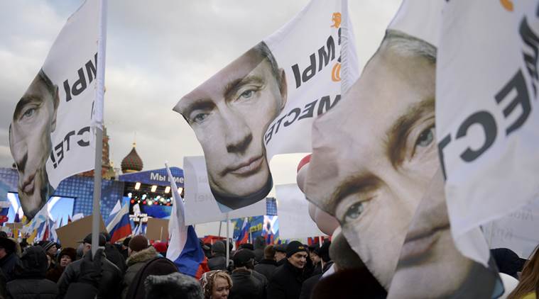 Banners bear the portrait of President Vladimir Putin and the slogan “We Are Together,” referring to Russia and Crimea, which Russia seized from Ukraine