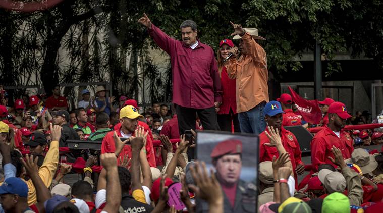 President Nicolás Maduro waves to government workers