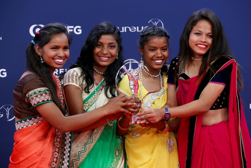 Neeta Kumari, Hema Kumari, Konika Kumari, and Radha Kumari pose after Yuwa-India wins the Sport for Good award