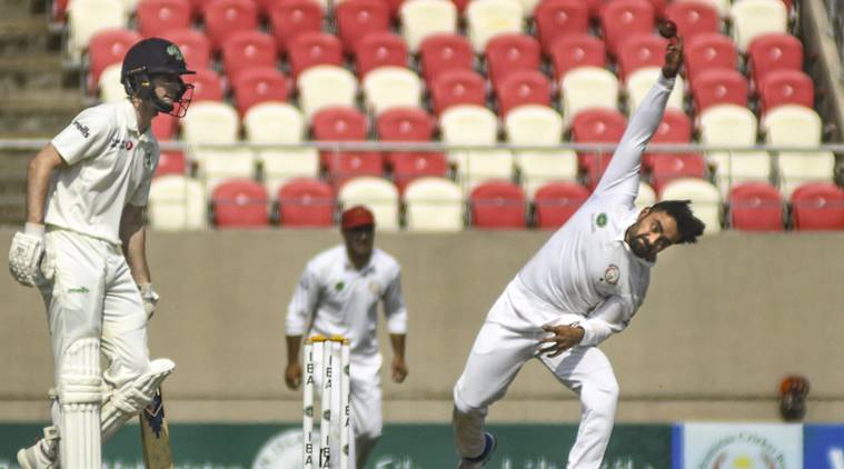 Afghanistani spinner Rashid Khan bowls during a match against Ireland in Dehradun.