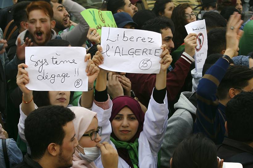 Algerian protestors celebrate as President Abdelaziz Bouteflika announces he won't seek another term
