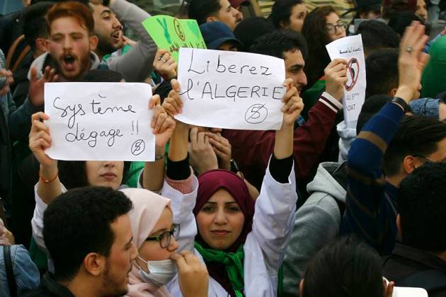 Algerian protestors celebrate as President Abdelaziz Bouteflika announces he won't seek another term