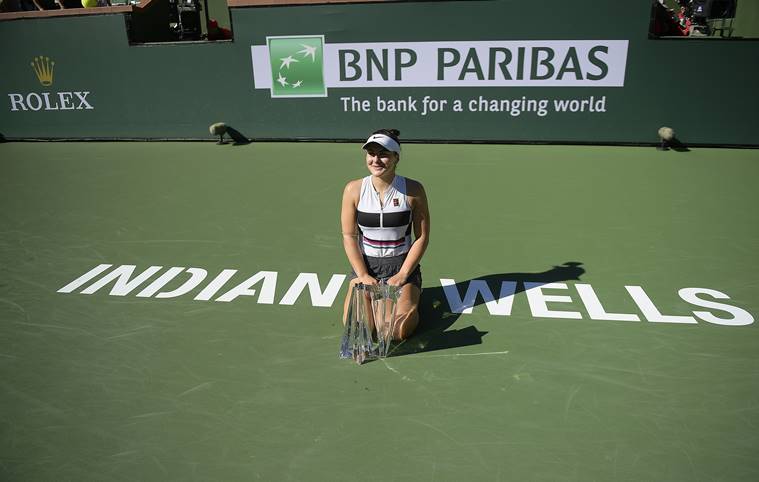 Bianca Andreescu, of Canada, poses for photos with her trophy after defeating Angelique Kerber, of Germany, in the women's final at the BNP Paribas Open tennis tournament
