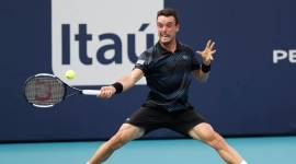 Roberto Bautista Agut of Spain hits a forehand against Novak Djokovic of Serbia (not pictured) in the fourth round of the Miami Open at Miami Open Tennis Complex.