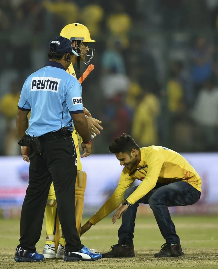 A pitch invader touches feet of CSK caption MS Dhoni after his team won their match of the Indian Premier League (IPL T20 2019) between Chennai Super Kings (CSK) and Delhi Capital (DC) at Feroz Shah Kotla Cricket Stadium.