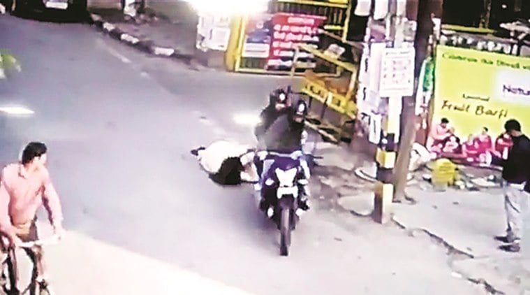 Footage from a nearby CCTV camera shows the woman waiting outside a residential colony when the men, wearing helmets, approach her on a motorcycle.