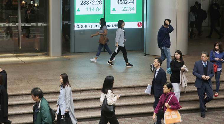 GLOBAL MARKETS - Asian shares fall on fresh rout in crude prices, End in sight for some lockdowns, Oil suffers as USO ETF sells front-month futures, Markets eye Fed and ECB meetings this week, world markets tuesday, business news india, indian express business news