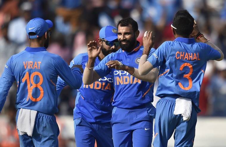 Mohammed Shami celebrates with teammate the dismissal of Australia's Glenn Maxwell on the first One Day International (ODI) series cricket match, at Rajiv Gandhi International Cricket Stadium in Hyderabad
