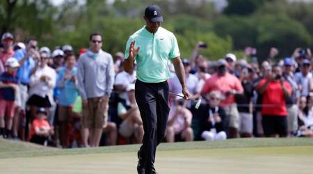 Tiger Woods waves to fans after a putt on the fifth hole during round-robin play at the Dell Match Play Championship golf tournament, Thursday, March 28, 2019, in Austin, Texas