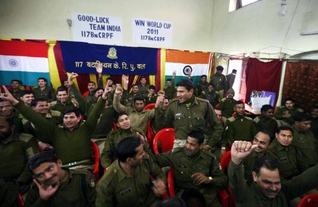 CRPF jawans react while watching the final match of the ICC Cricket World Cup 2011 between India and Sri lanka on a big screen at their base in Srinagar