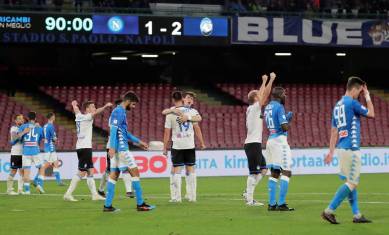 Atalanta players celebrate after the match as Napoli players look dejected