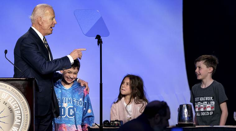 Joe Biden jokes about hugging in a speech, then offers a mixed apology