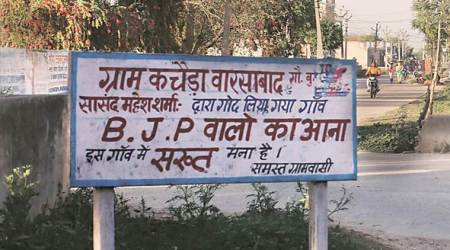 The signboard outside the village in Greater Noida. (Express photo by Amit Mehra)