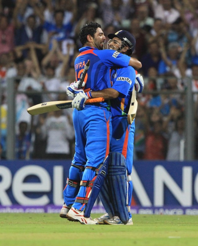 Yuvraj singh runs to embrace dhoni after the later lifted for sixer as a match winner in the world cup 2011 in mumbai