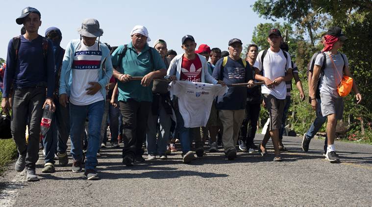 Migrants break border gate, force their way into Mexico