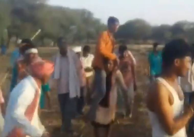 MP woman video, woman carrying husband on shoulder video, Jhabua district, woman carrying husband video, mp women punishment, Jhabua woman video, video india news, indian express