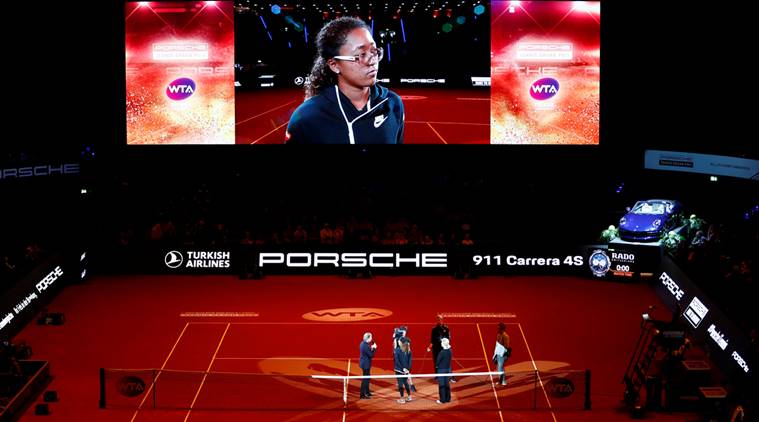 Japan's Naomi Osaka is interviewed on the court after she withdrew from her semi final match against Estonia's Anett Kontaveit due to injury