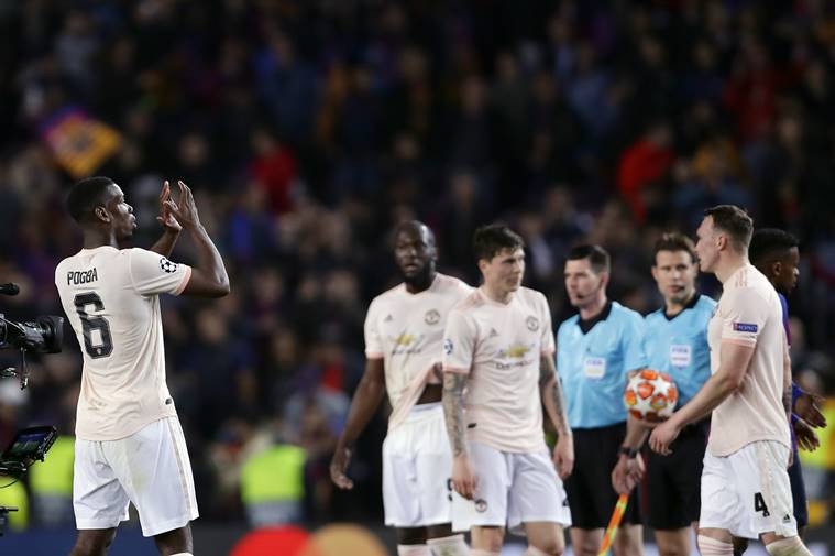 Manchester United's Paul Pogba, left, applauds to supporters at the end of the Champions League quarterfinal, second leg, soccer match between FC Barcelona and Manchester United at the Camp Nou stadium in Barcelona, Spain