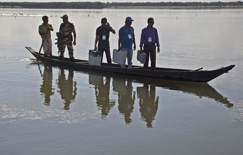 Election officials sail boats, trek hills to carry voting machines