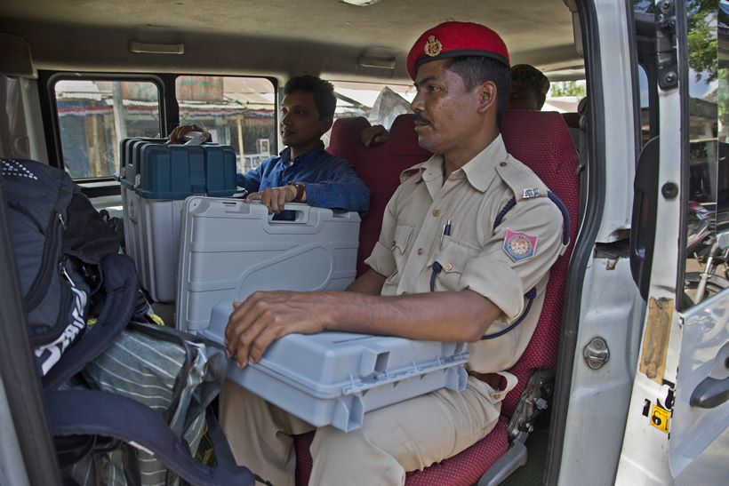 Election officials sail boats, trek hills to carry voting machines