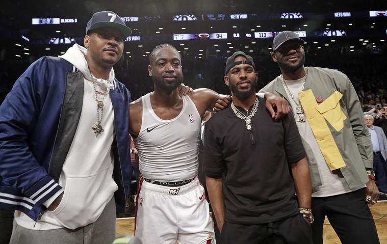 Carmelo Anthony, Miami Heat guard Dwyane Wade, Houston Rockets guard Chris Paul and Los Angeles Lakers forward LeBron James. from left, pose for a photographs on the court after Wade's final NBA basketball game