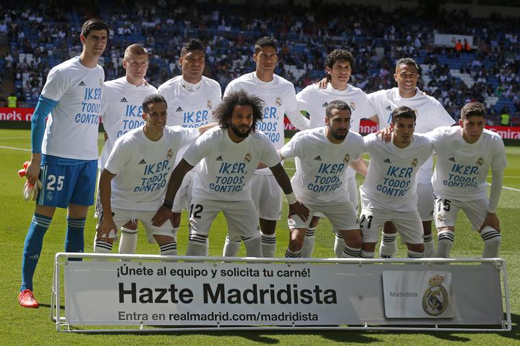 Real Madrid team players pose with shirts supporting former club goalkeeper Iker Casillas before a Spanish La Liga soccer match between Real Madrid and Villarreal at the Santiago Bernabeu stadium in Madrid, Spain