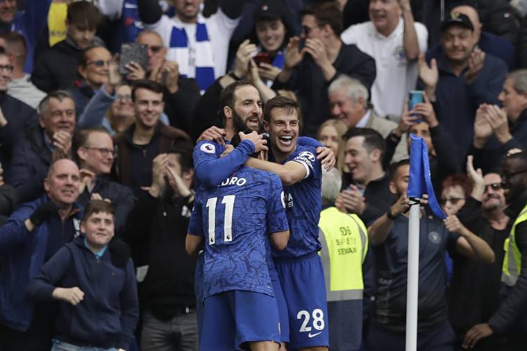 Chelsea's Gonzalo Higuain, left, celebrates with teammate Cesar Azpilicueta, right, and Pedro after scoring his side's third goal during the English Premier League soccer match between Chelsea and Watford at Stamford Bridge stadium in London
