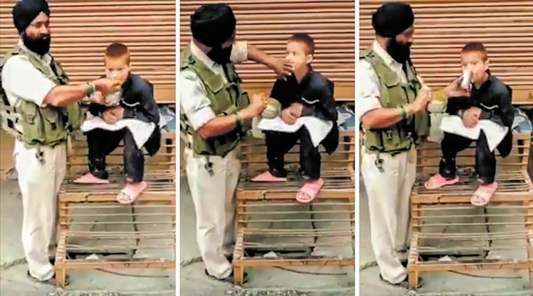 crpf, crpf feeding child, crpf jawan feeding child, jawan feeding child viral video, jammu kashmir, Srinagar, CRPF Srinagar jawan child viral video, indian express, indian express news