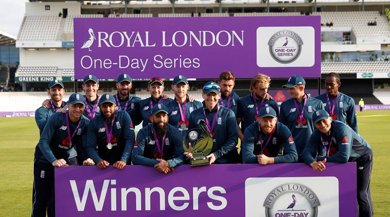 England players pose as they celebrate winning the match with the trophy