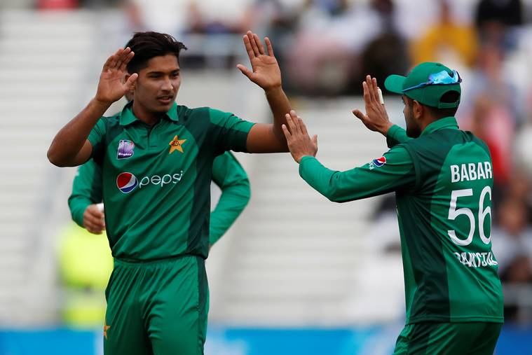 Pakistan's Mohammad Hasnain celebrates with Babar Azam after taking the wicket of England's Joe Root