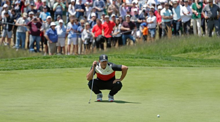 Brooks Koepka lines up a putt on the fifth green during the first round of the PGA Championship golf tournament