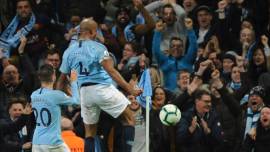 Manchester City's Vincent Kompany, right, celebrates after scoring his side's opening goal during the English Premier League soccer match between Manchester City and Leicester City at the Etihad stadium in Manchester