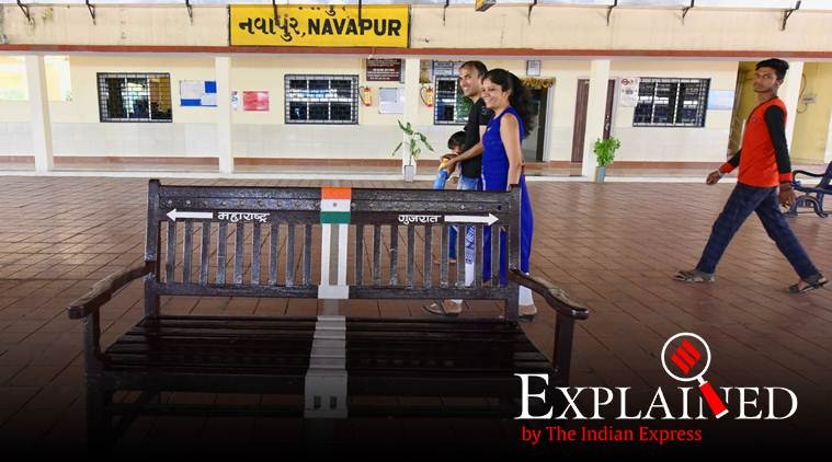 navapur-01
Gujarat state was parted from Bombay state on 1st May 1960. Apart from this the left out Bombay state was named as Maharashtra. On 1st May, people of both these neighbouring state celebrates this day.
But one unique thing which connects both these States is Navapur railway station. Half portion of this railway station lies in Navapur and half in Gujarat. 
A yellow line had been painted on the walkway at Navapur railway station which shows Gujarat area and Maharashtra area. The railway authorities had also installed a bench at Navapur Railway station in the mid and on the border yellow strip which attracts large number of passengers who seats on this bench which also has yellow strip of dividing both states. People seats on the bench takes selfie in their mobile phones. This bench also had become selfie point for the people. One more amazing thing of this railway station is that the passengers ticket counter lies in the Gujarat border while passengers stands in queue in Maharashtra border. Here the train announcement is done in English, Hindi, Gujarati and Marathi. When train coming towards Maharashtra, from Gujarat its engine lies in Navapur in Maharashtra while its boggies lies in Gujarat border. express photo javed raja