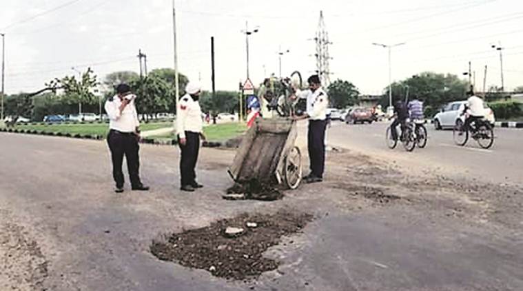Chandigarh: Traffic cops turn up to fix potholes
