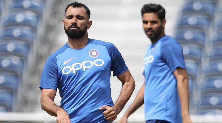 India's Bhuvneshwar Kumar watches Mohammed Shami
