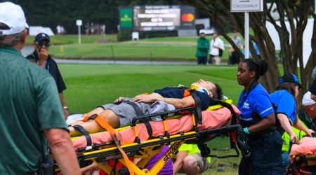 A spectator is taken to an ambulance after a lightning strike on the course which left several injured during a weather delay in the third round of the Tour Championship golf tournament Saturday, Aug. 24, 2019, in Atlanta. (AP Photo/John Amis)