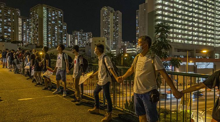 Hong Kong protesters, calling for direct elections, join hands across city