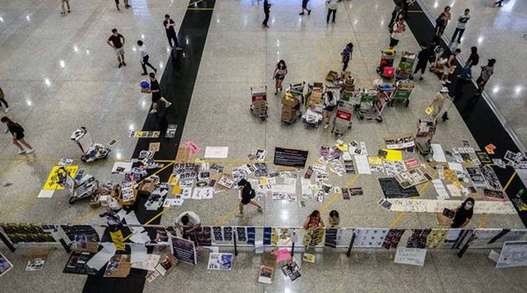 Hong Kong Airport cleans up as Trump warns on Chinese troops