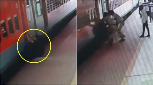 indian railways, rpf saves man train accident, man falls running train, man slips catching running train, ashram express, indian express, viral video