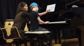 Miira Pasma teaching students to play the piano in Halikko, Finland.