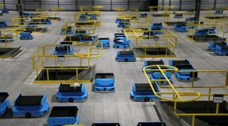 amazon robots, amazon workers, robot helping humans in their work, workers adapting to working with robots