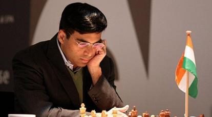 V. P. Kaushik, 11, watches as Indian World Rapid Chess Champion Viswanathan  Anand, unseen right, makes a move at the launch of a school chess  tournament organized by the NIIT Mind Champion's