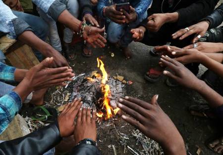 A group of yoths enjoying bone fire heat, during chilled friday in Lucknow,after the rains and cold wave temperature dropped down.Express photo by Vishal Srivastav 13122019