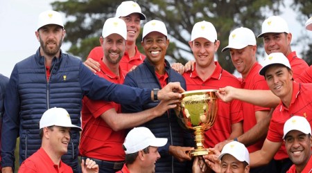 Melbourne: U.S. team player and captain Tiger Woods, center, holds the trophy with his players after the U.S. team won the President's Cup golf tournament at Royal Melbourne Golf Club in Melbourne, Sunday, Dec. 15, 2019. The U.S. team won the tournament 16-14. AP/PTI Photo(AP12_15_2019_000031B)