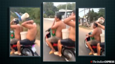 Vietnam, two men bathe on bike, men bike ride bath viral video, police investigation, bathing on motorbike, trending, indian express, indian express enws
