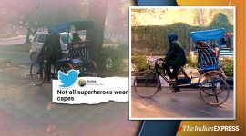 rickshawala wraps dog in blanket, delhi rickshaw puller dog blanket photo, rickshaw puller take care of stray dogs, delhi winters, viral news, indian express, good news, delhi weather today