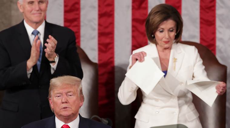 House Speaker Nancy Pelosi (right) tears a copy of US President Donald Trump's speech