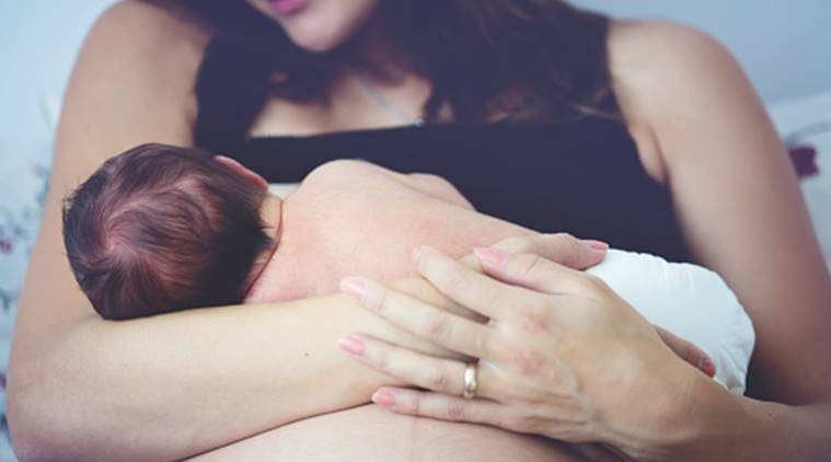 Mother and baby breastfeeding