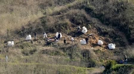 FILE - In this Tuesday, Jan. 28, 2020, file photo, investigators work at the scene of a helicopter crash that killed former NBA basketball player Kobe Bryant, his 13-year-old daughter, Gianna, and seven others, in Calabasas, Calif. Federal investigators say wreckage from the helicopter that crashed last month and killed Bryant, his daughter and seven others did not show any outward evidence of engine failure, the National Transportation Safety Board said Friday, Feb. 7, 2020. (AP Photo/Mark J. Terrill, File)