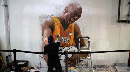 Muralist Jonas Never paints a portrait of late retired basketball player Kobe Bryant at the Grand Central Market in Los Angeles, California, U.S. February 5, 2020. REUTERS/Chris Helgren